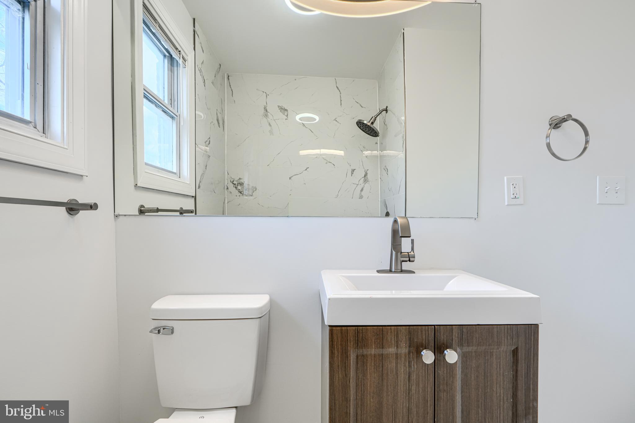 4400 Manorview Road Baltimore, MD 21229 - Photo 11 of 30 a bathroom with a sink a toilet and shower