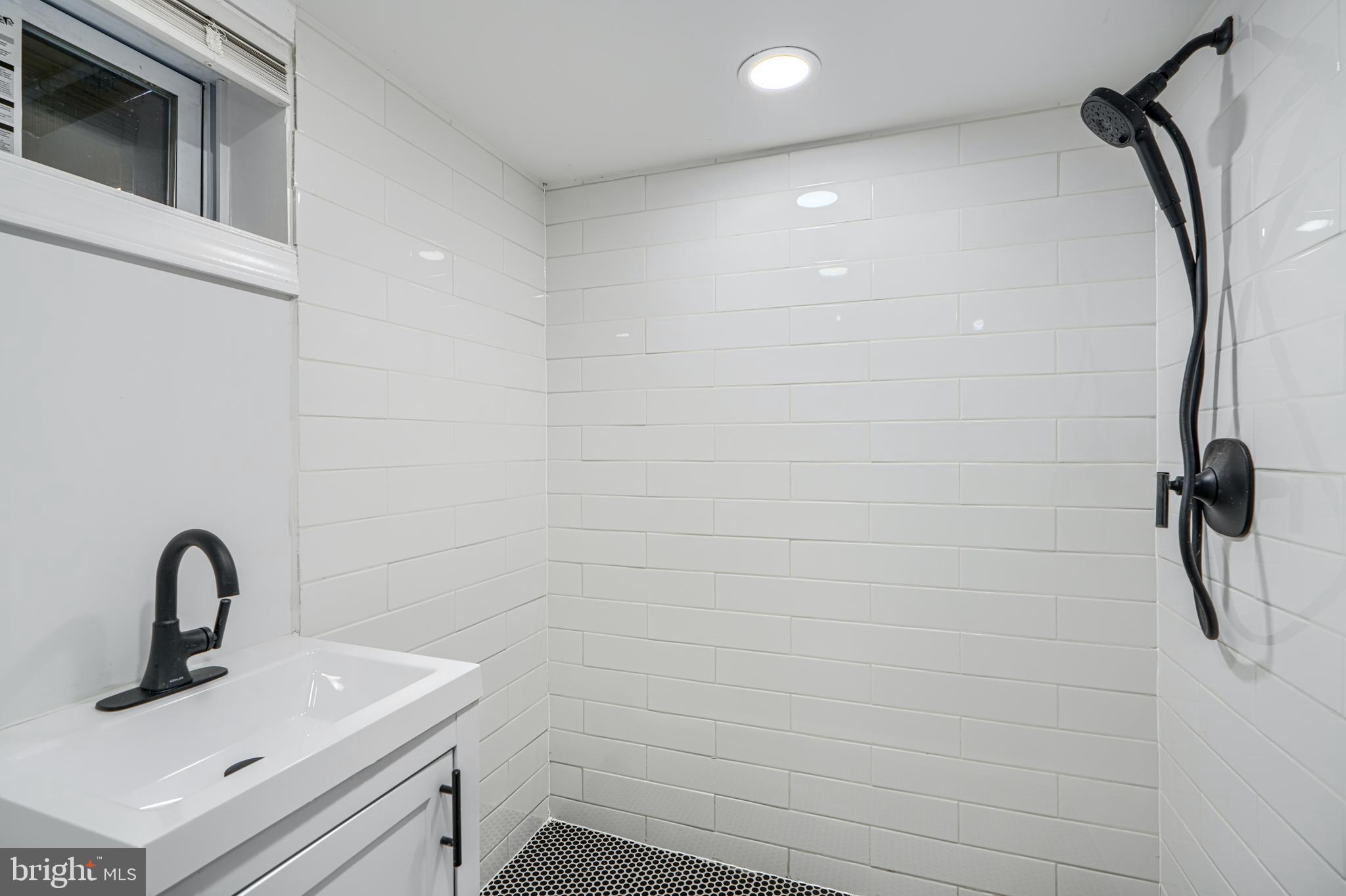 4400 Manorview Road Baltimore, MD 21229 - Photo 20 of 30 a bathroom with a sink a vanity and a shower
