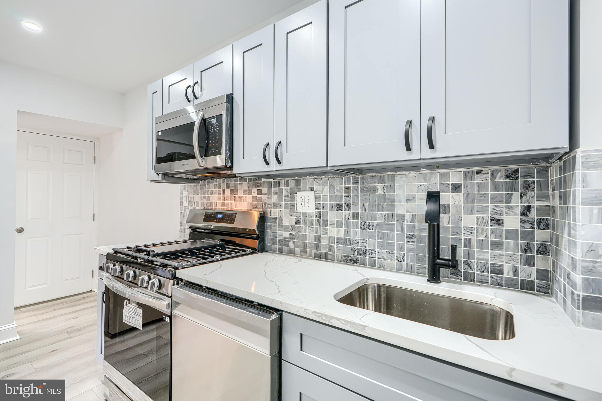 4400 Manorview Road Baltimore, MD 21229 - Photo 2 of 30 a kitchen with granite countertop a sink a stove and cabinets