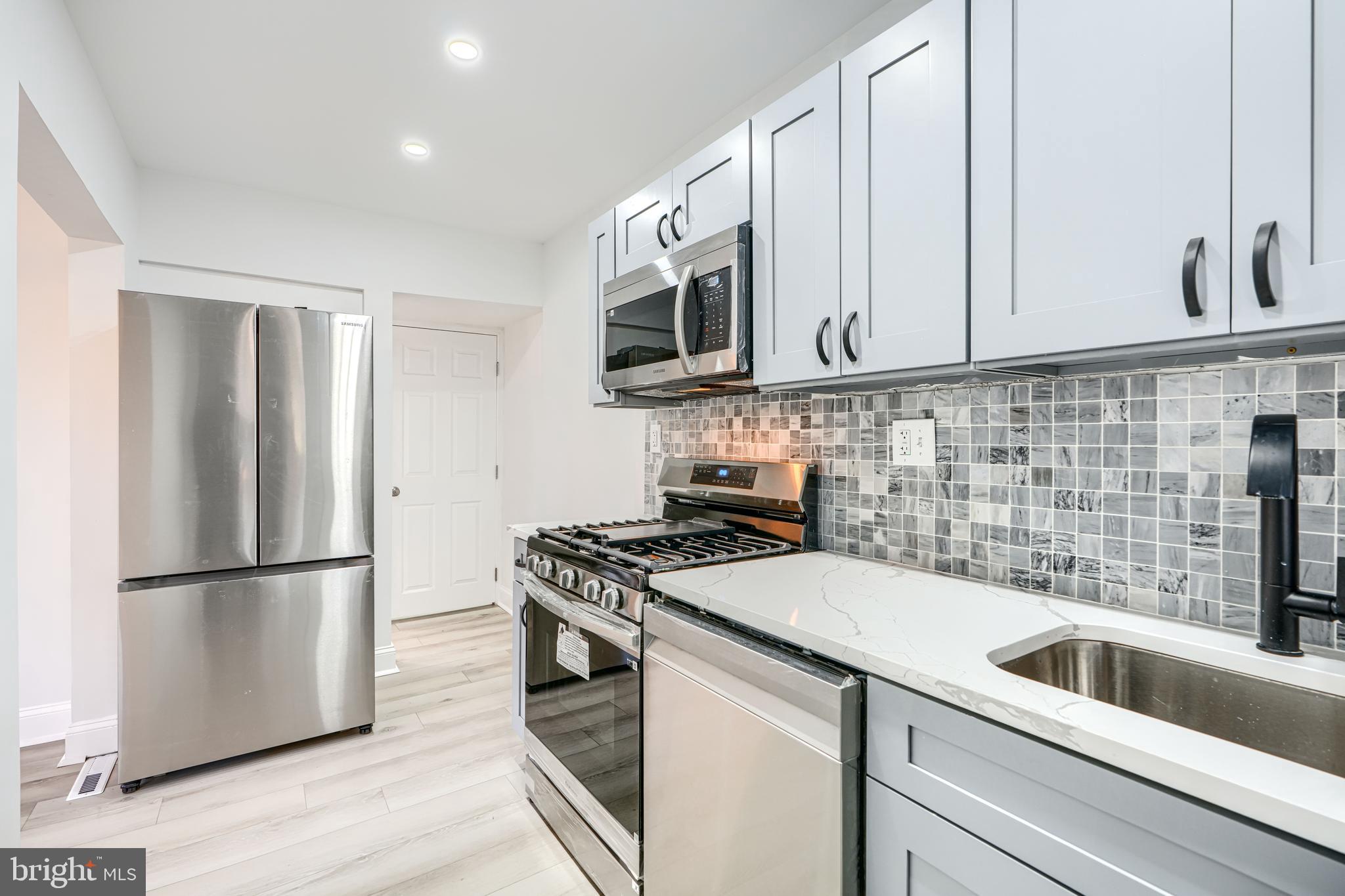 4400 Manorview Road Baltimore, MD 21229 - Photo 3 of 30 a kitchen with a sink stove and refrigerator