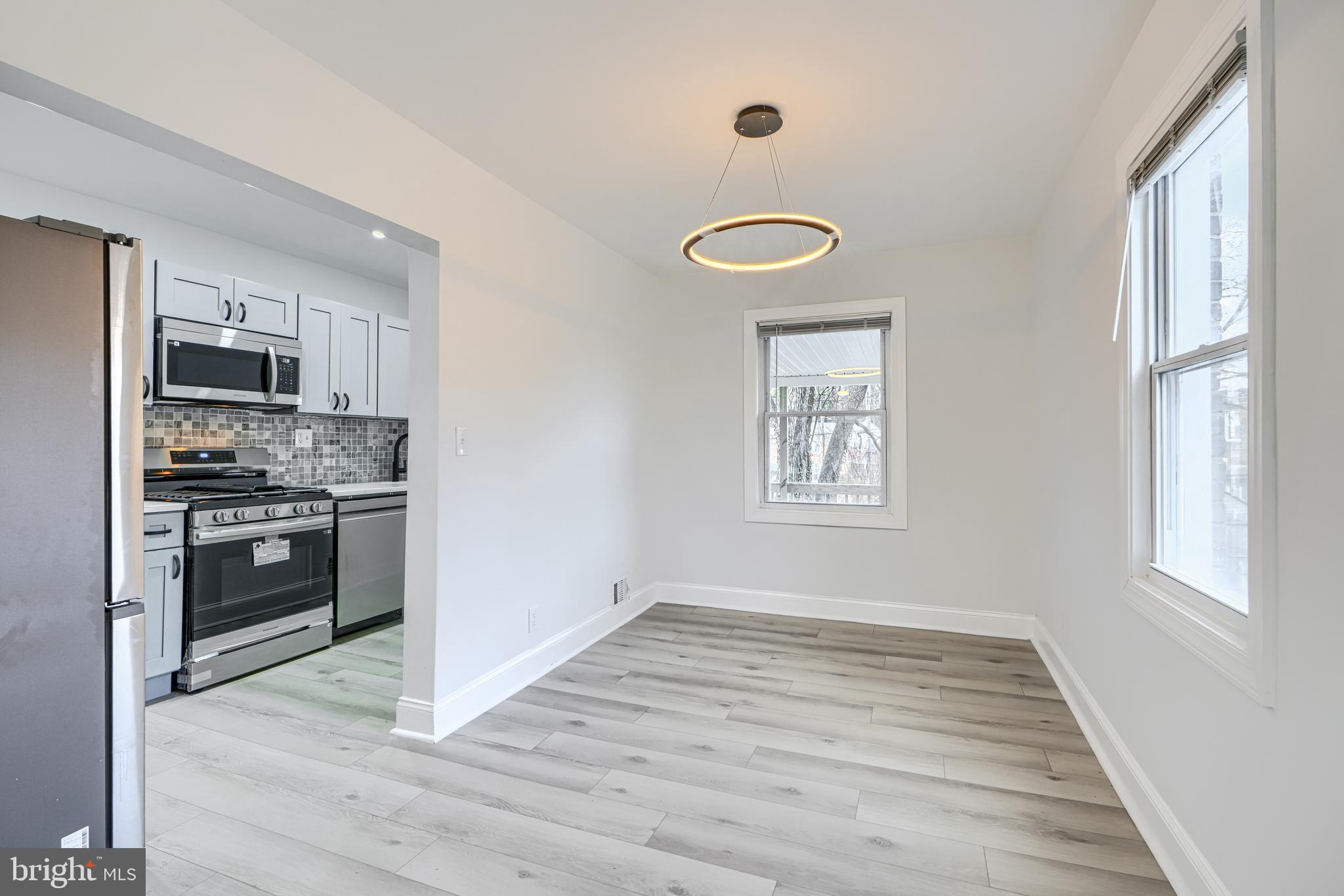 4400 Manorview Road Baltimore, MD 21229 - Photo 5 of 30 a kitchen with granite countertop a refrigerator and a stove top oven
