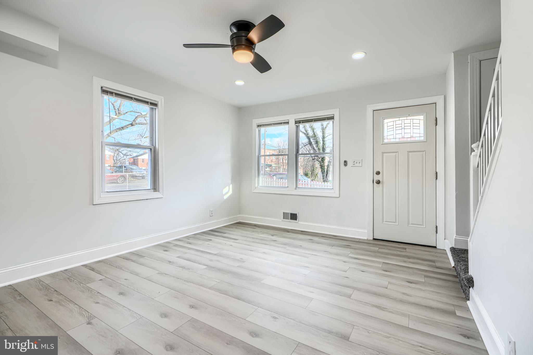 4400 Manorview Road Baltimore, MD 21229 - Photo 7 of 30 a view of an empty room with a window and wooden floor