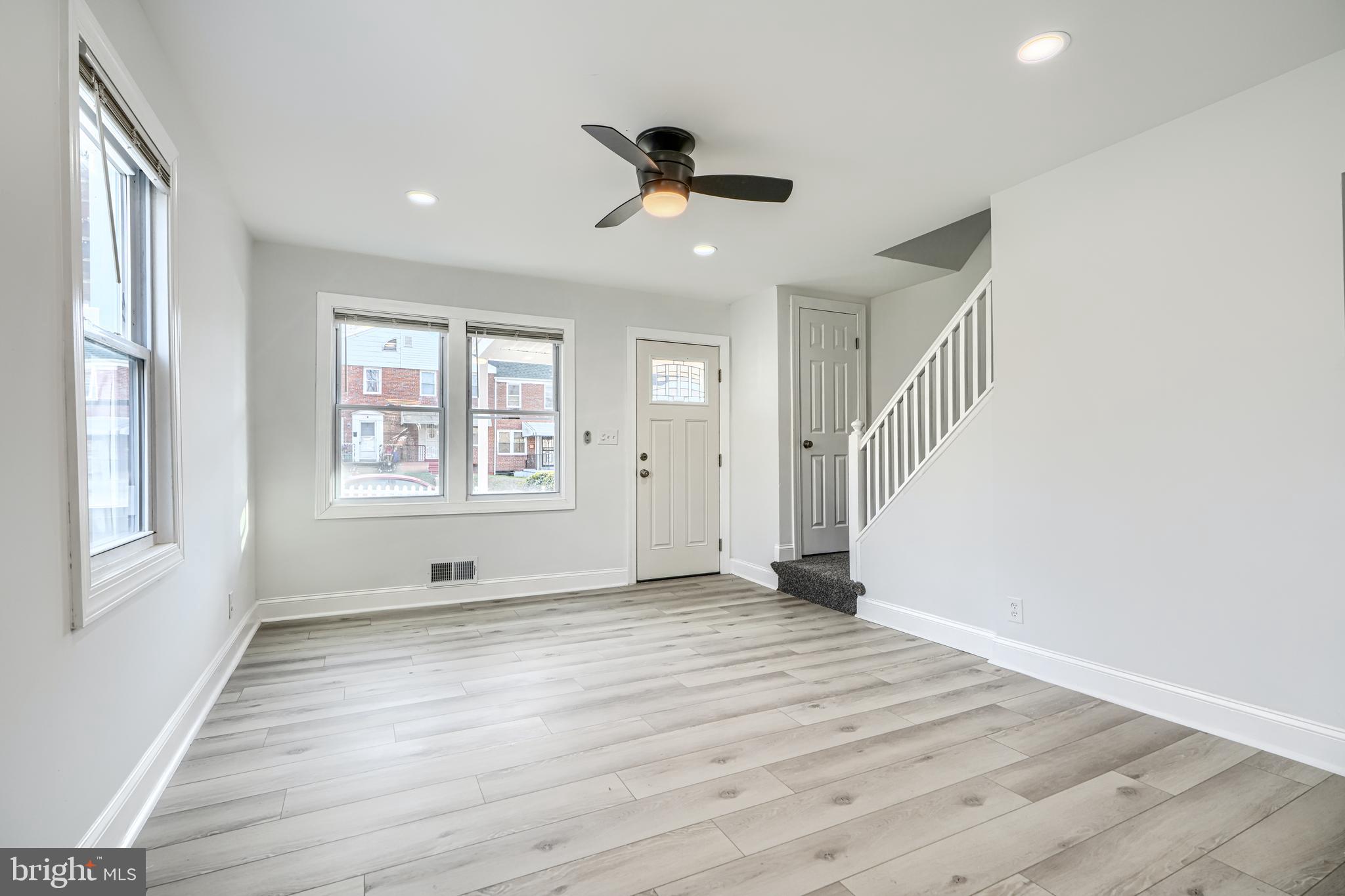 4400 Manorview Road Baltimore, MD 21229 - Photo 8 of 30 wooden floor in an empty room with a window and a ceiling fan