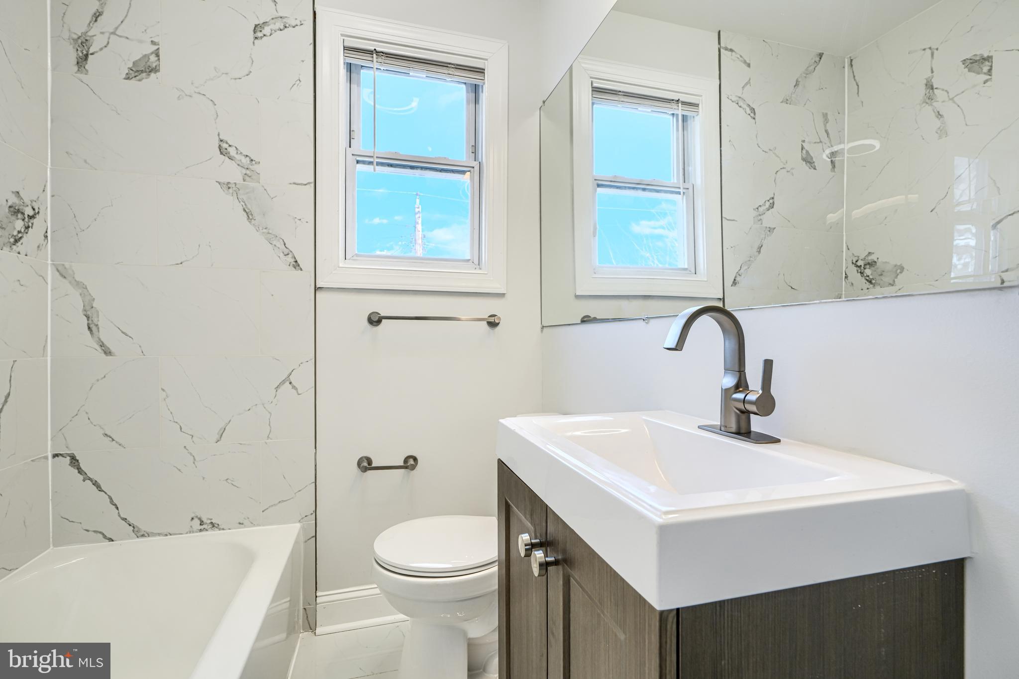 4400 Manorview Road Baltimore, MD 21229 - Photo 10 of 30 a bathroom with a sink a toilet and shower
