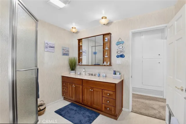 a bathroom with a sink and a clock on the wall