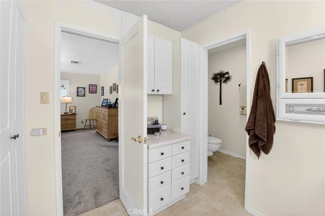 a view of a house with a yard and potted plants