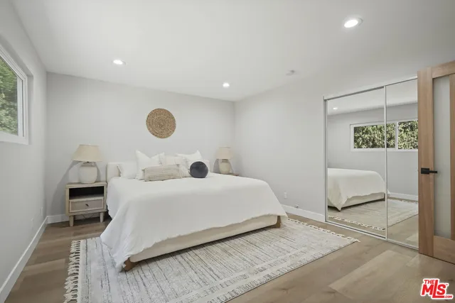 a bedroom with a bed and a chair