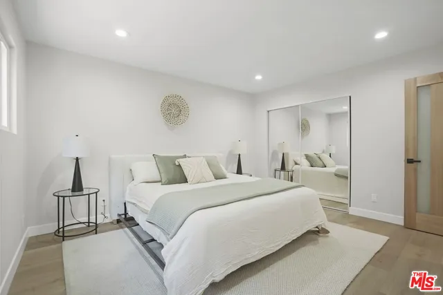 a bedroom with a bed and a lamp