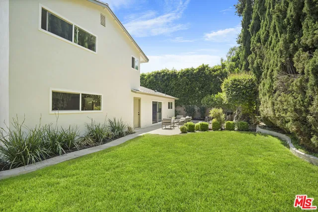a view of a backyard of the house