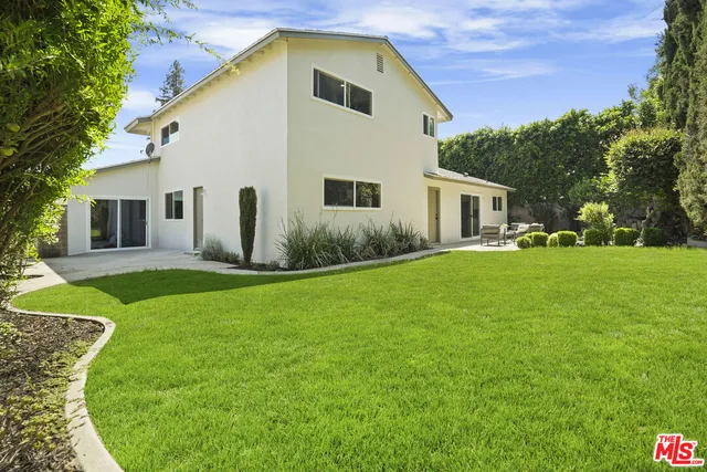 a view of house with backyard