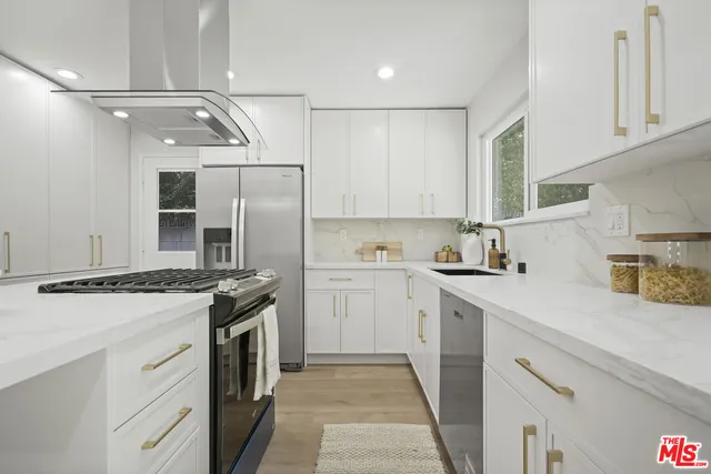 a kitchen with a stove sink and refrigerator