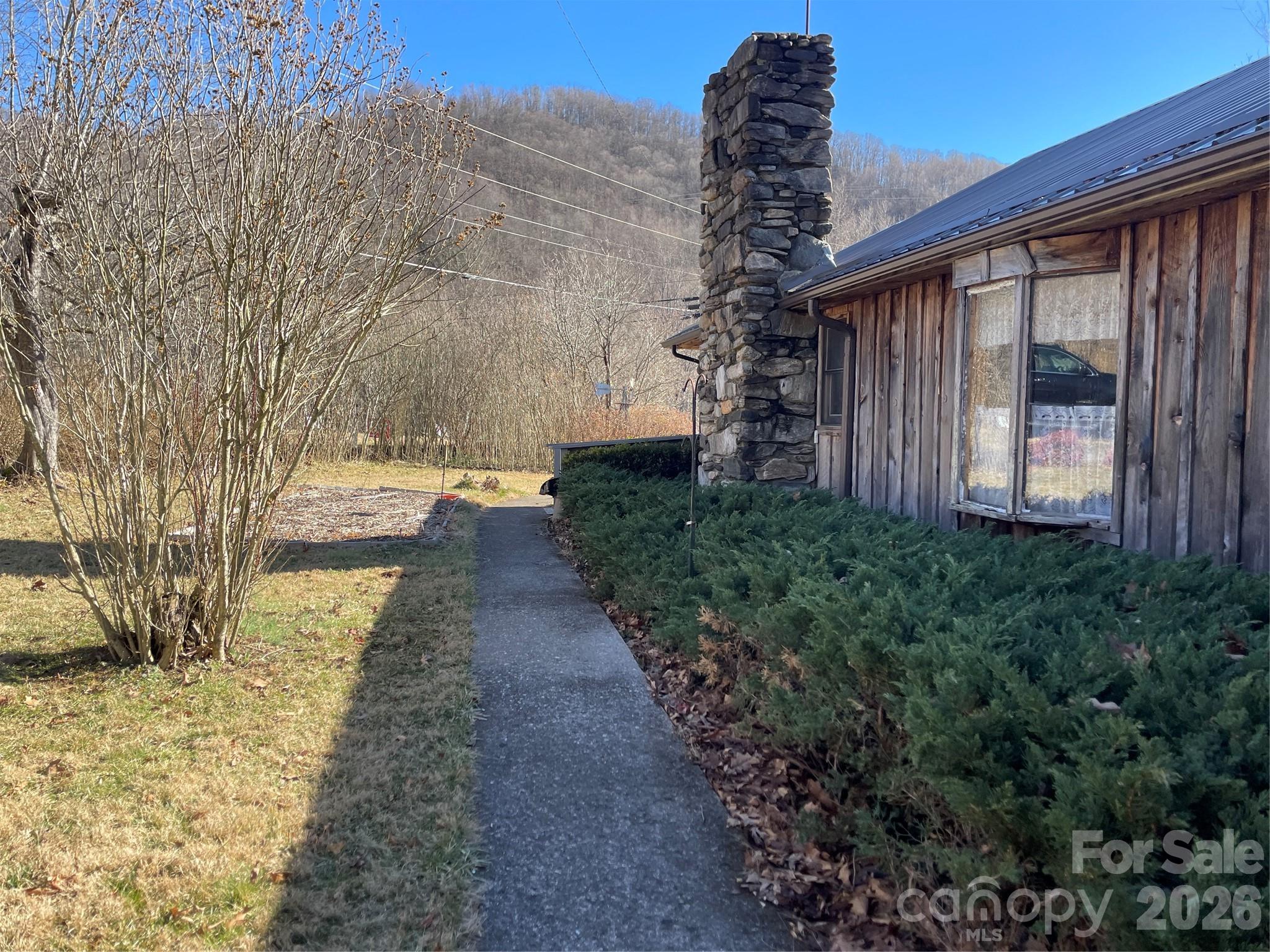 29 Cook Town Road Bakersville, NC 28705 - Photo 2 of 14 a pathway of a house with a yard