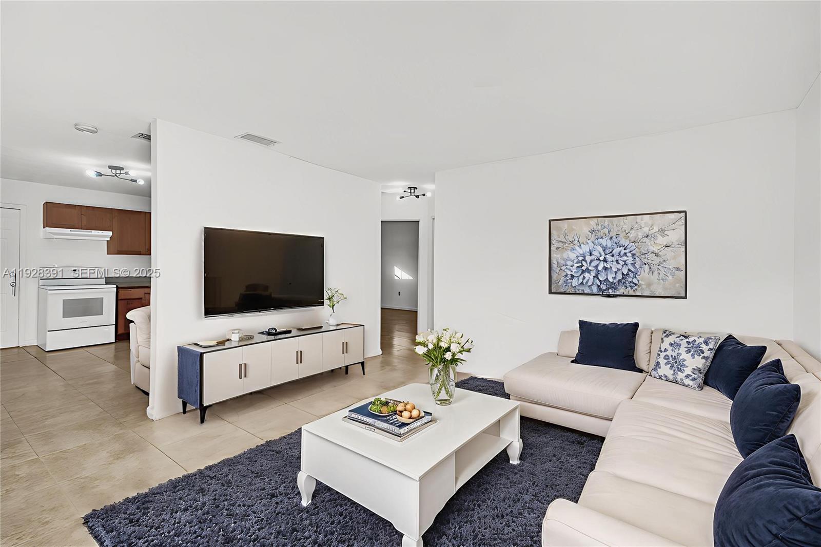 2907 Northwest 103rd Street, Unit 1 Miami, FL 33147 - Photo 1 of 38 a living room with furniture and a flat screen tv
