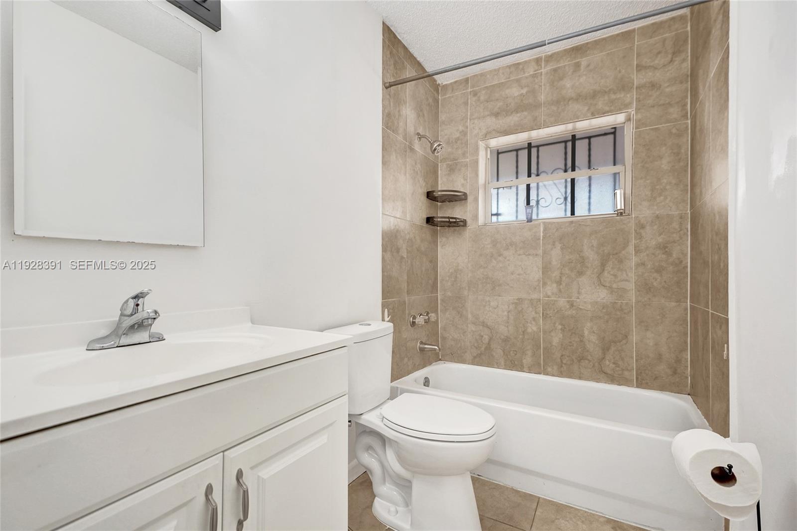 2907 Northwest 103rd Street, Unit 1 Miami, FL 33147 - Photo 20 of 38 a bathroom with a sink a toilet and shower