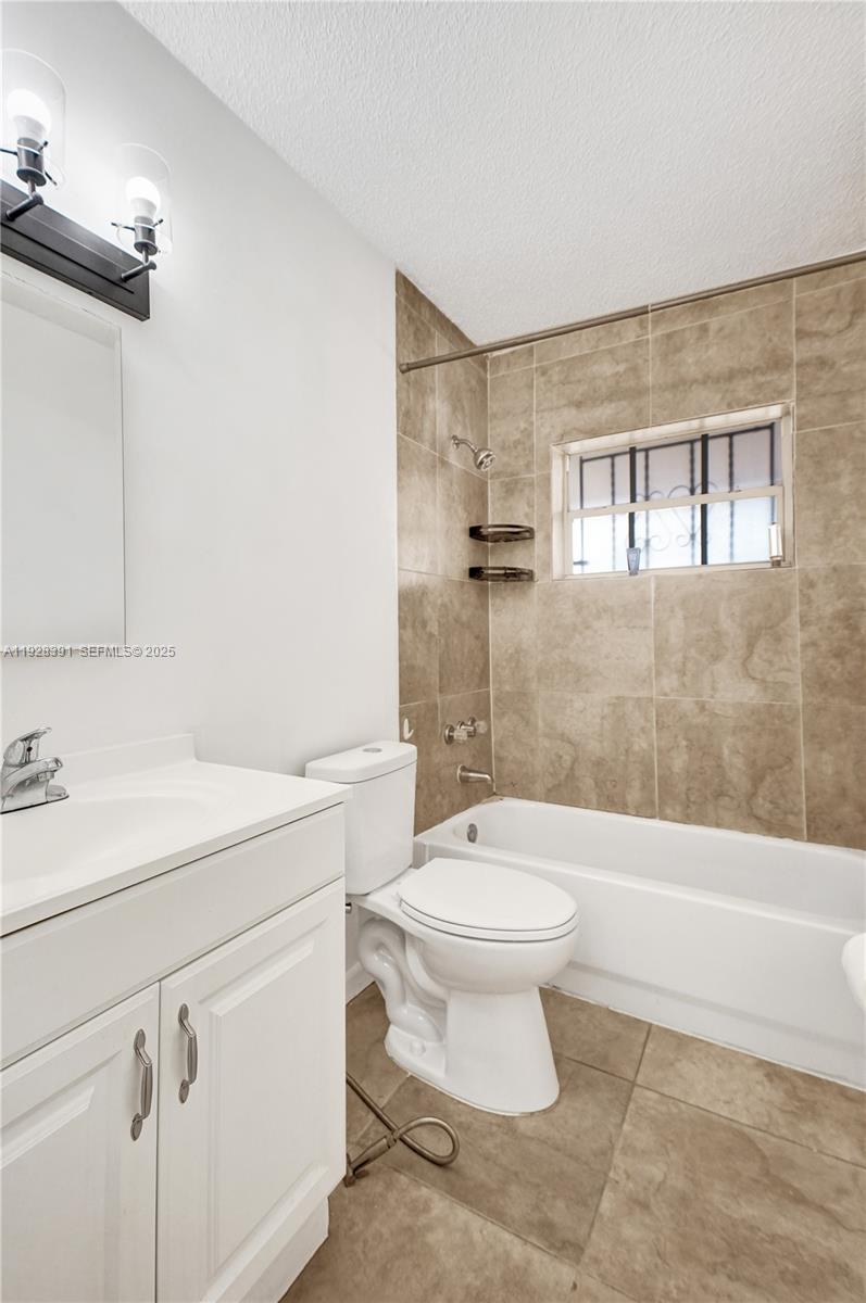 2907 Northwest 103rd Street, Unit 1 Miami, FL 33147 - Photo 21 of 38 a bathroom with a sink a toilet and a bathtub