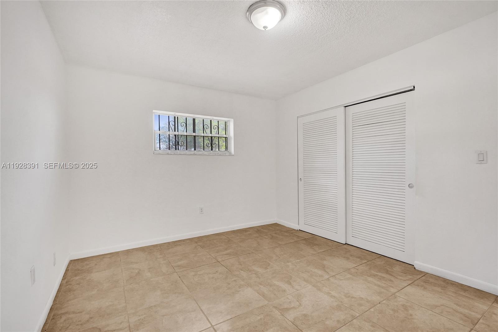 2907 Northwest 103rd Street, Unit 1 Miami, FL 33147 - Photo 24 of 38 an empty room with a empty space and windows