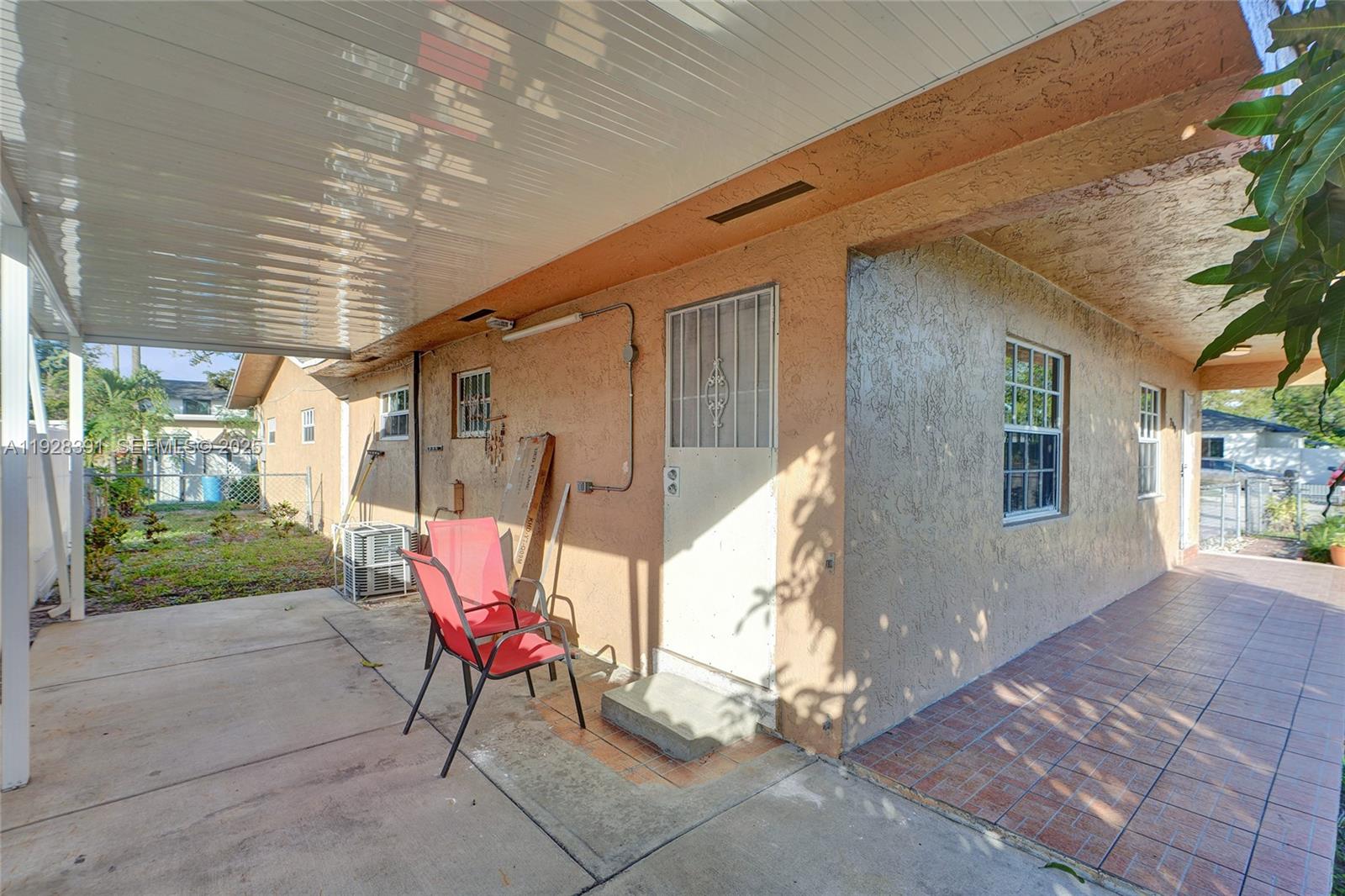 2907 Northwest 103rd Street, Unit 1 Miami, FL 33147 - Photo 27 of 38 a backyard of a house with outdoor seating