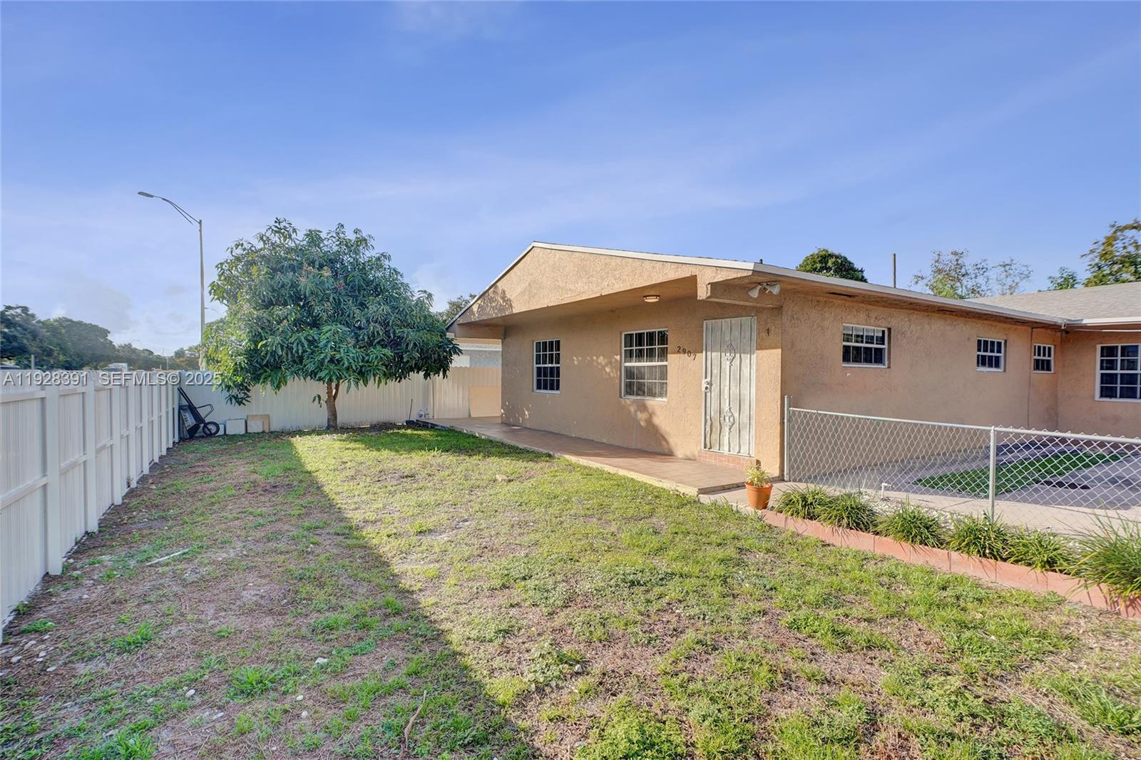 2907 Northwest 103rd Street, Unit 1 Miami, FL 33147 - Photo 29 of 38 a view of a backyard of the house