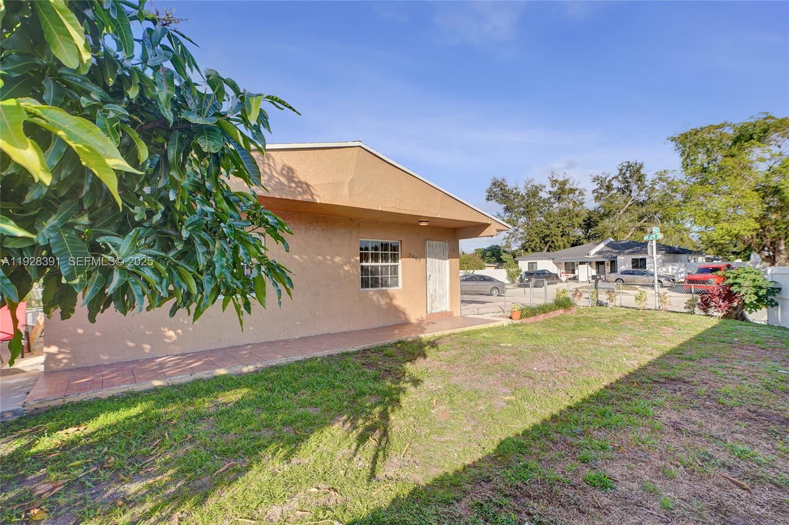 2907 Northwest 103rd Street, Unit 1 Miami, FL 33147 - Photo 31 of 38 a front view of a house with a garden and yard