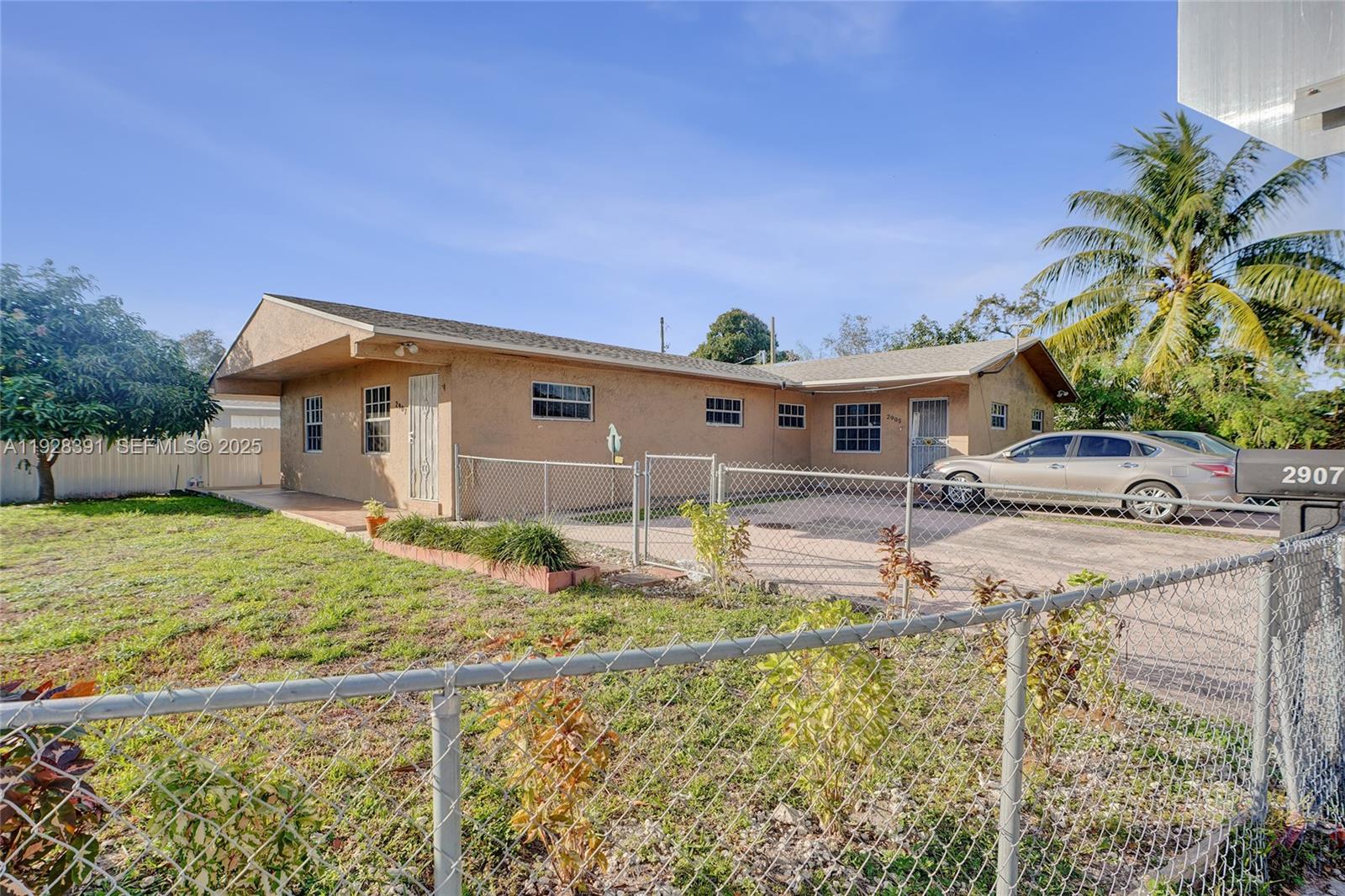 2907 Northwest 103rd Street, Unit 1 Miami, FL 33147 - Photo 37 of 38 a front view of a house with garden