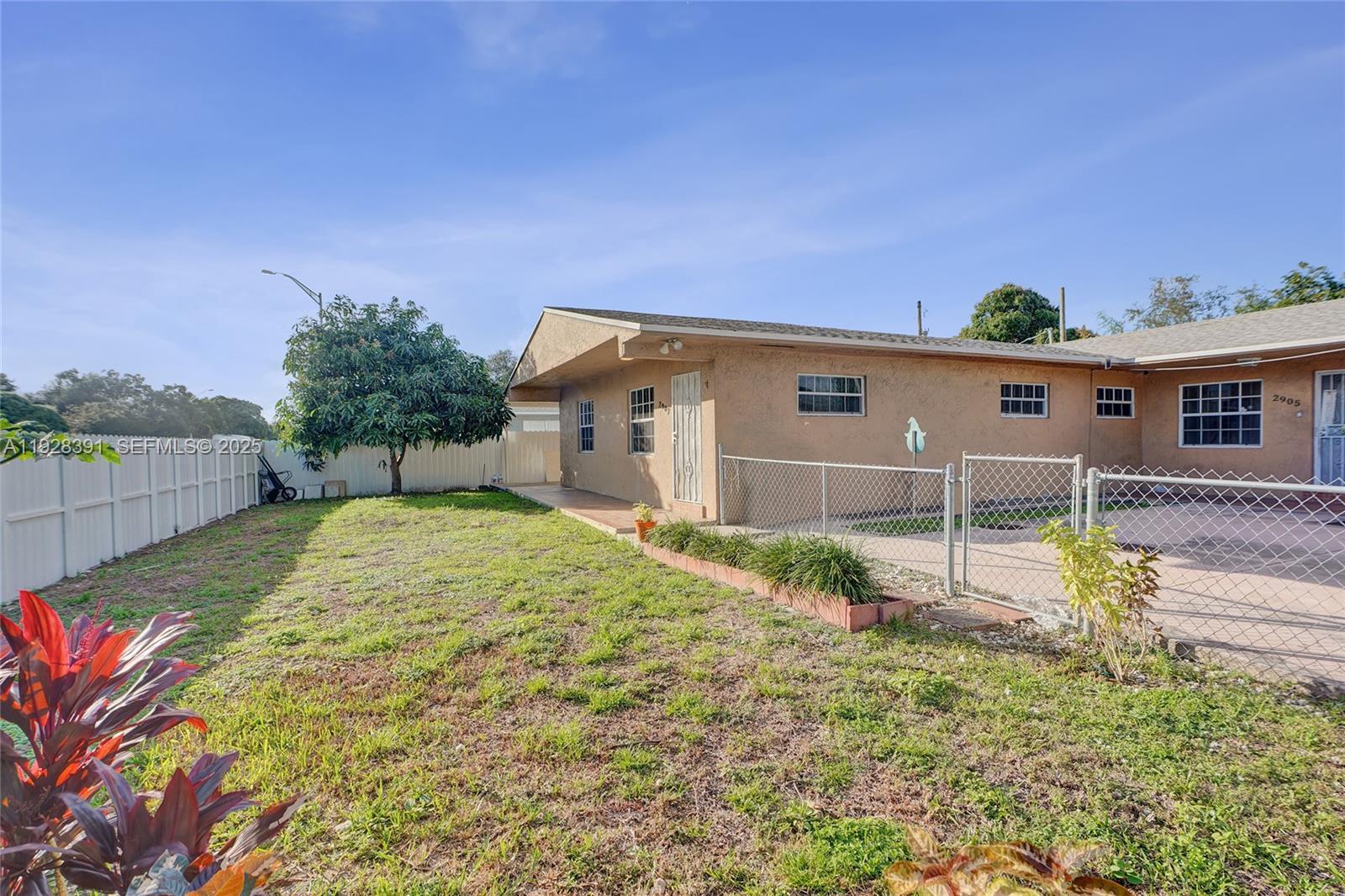 2907 Northwest 103rd Street, Unit 1 Miami, FL 33147 - Photo 38 of 38 a backyard of a house with a yard