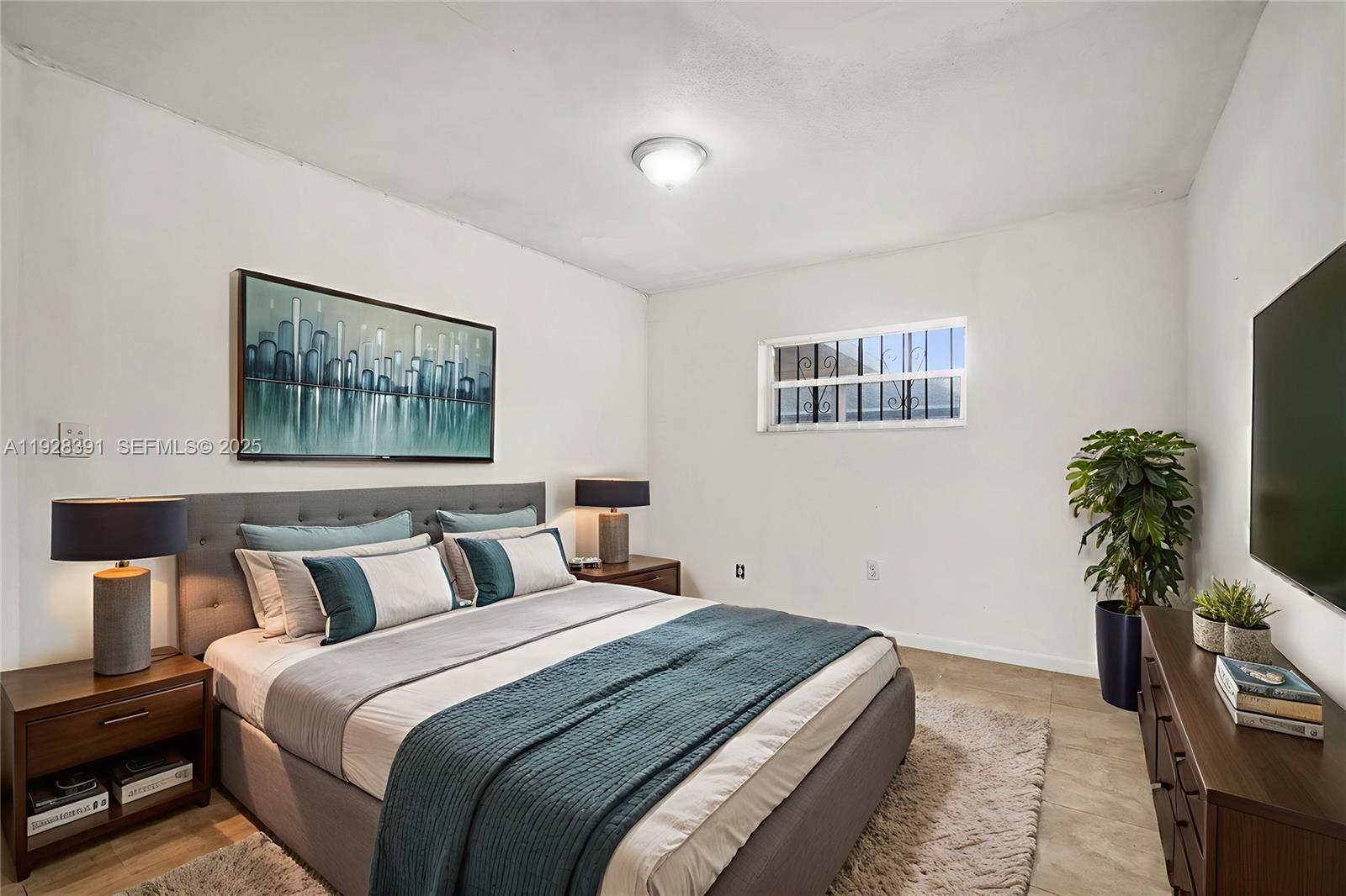 2907 Northwest 103rd Street, Unit 1 Miami, FL 33147 - Photo 5 of 38 a bedroom with bed and window