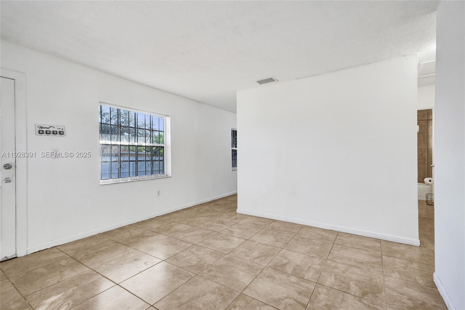 2907 Northwest 103rd Street, Unit 1 Miami, FL 33147 - Photo 7 of 38 a view of an empty room with a window