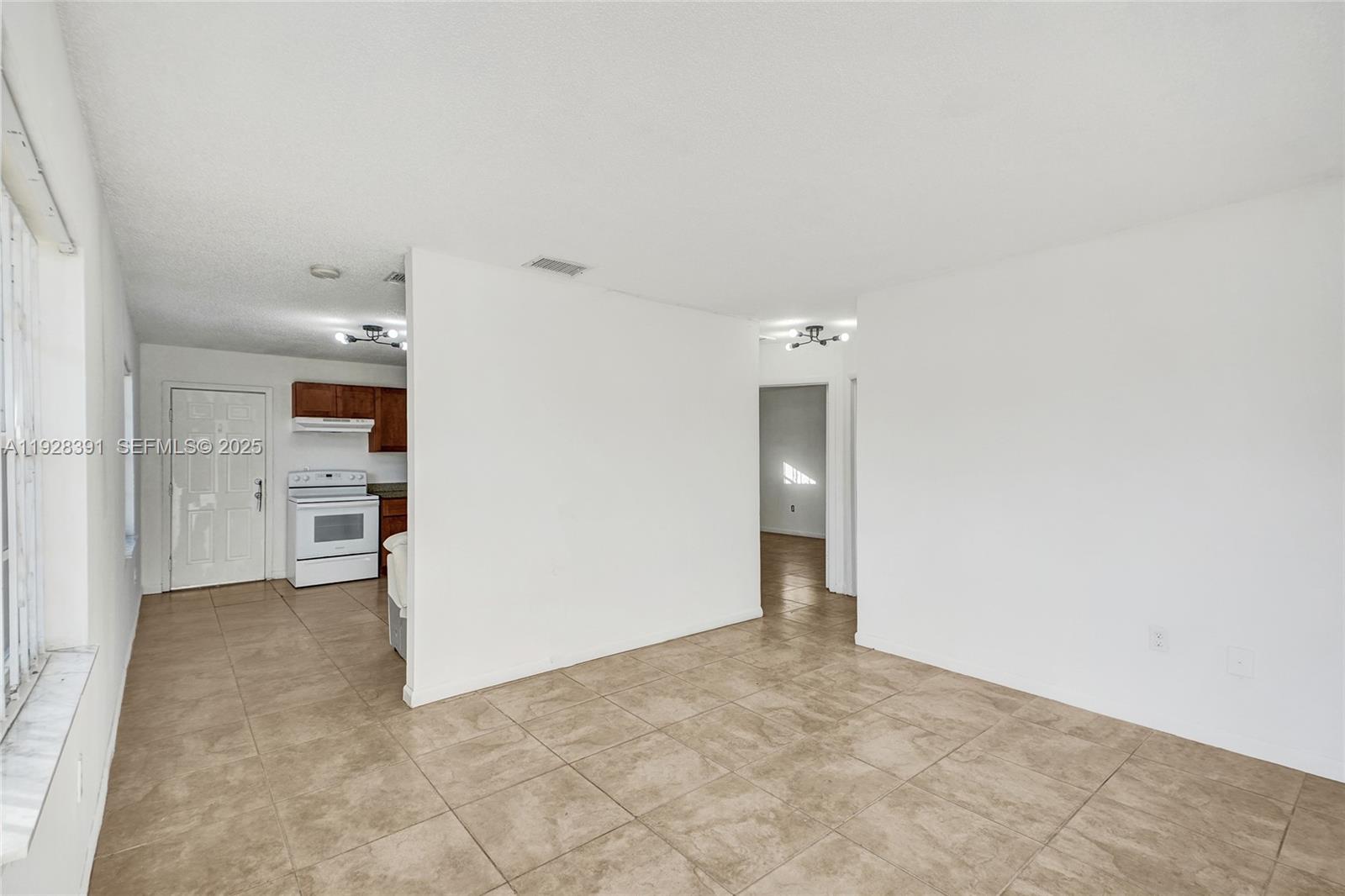 2907 Northwest 103rd Street, Unit 1 Miami, FL 33147 - Photo 8 of 38 a view of a big room with closet and windows