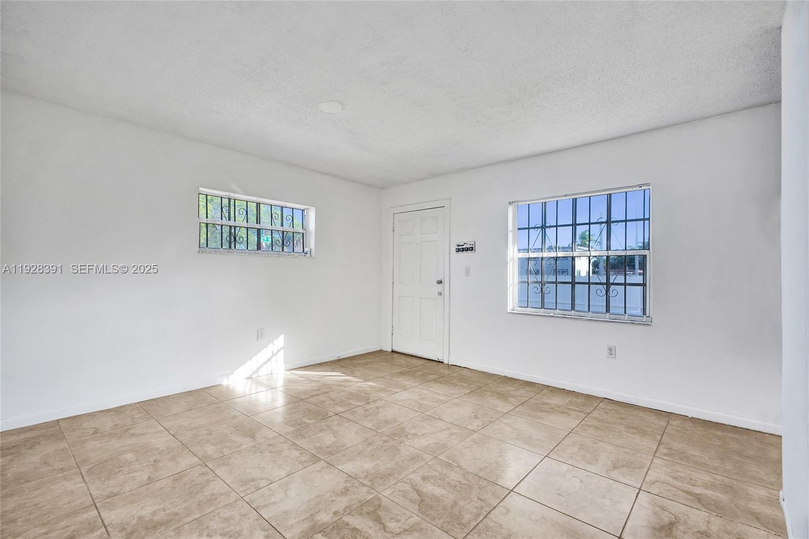 2907 Northwest 103rd Street, Unit 1 Miami, FL 33147 - Photo 10 of 38 a view of an empty room with a window