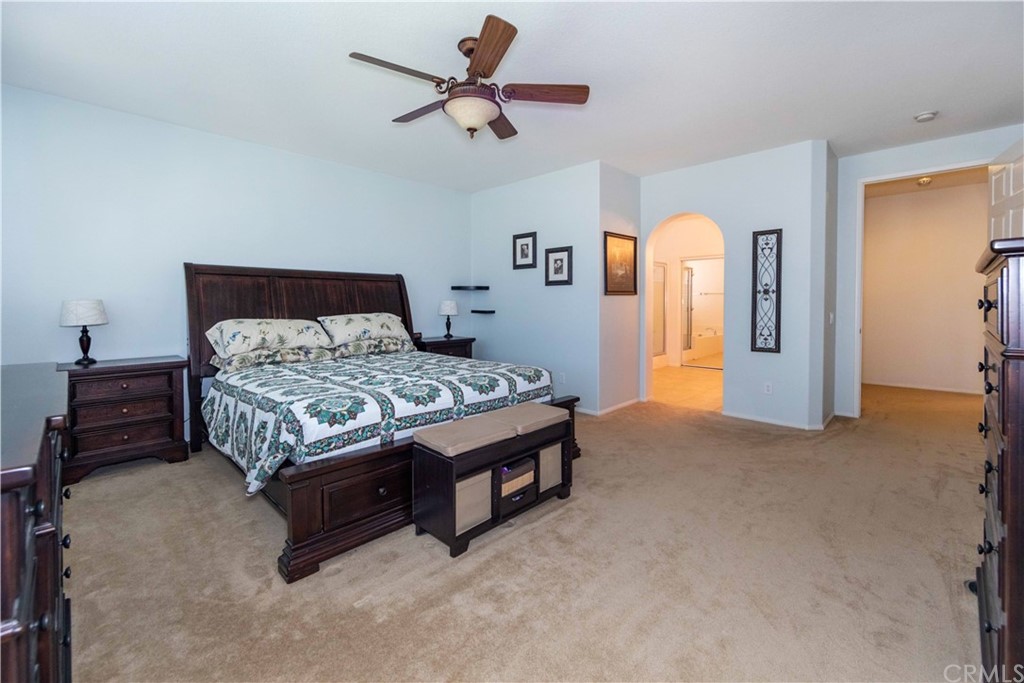 31271 Ensemble Drive Menifee, CA 92584 - Photo 13 of 30 a bedroom with a bed and a chandelier