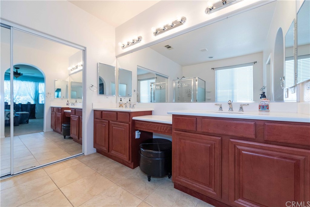 31271 Ensemble Drive Menifee, CA 92584 - Photo 14 of 30 a large bathroom with a sink a vanity and a large mirror