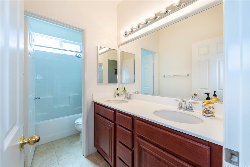 31271 Ensemble Drive Menifee, CA 92584 - Photo 18 of 30 a bathroom with a sink a toilet and shower