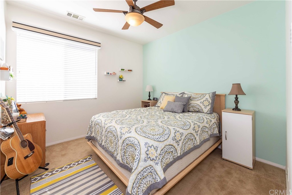 31271 Ensemble Drive Menifee, CA 92584 - Photo 19 of 30 a bedroom with a bed and window