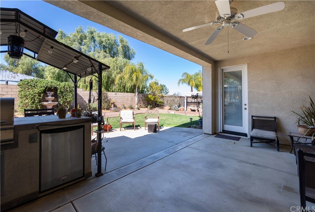 31271 Ensemble Drive Menifee, CA 92584 - Photo 27 of 30 a view of living room with patio furniture and a floor to ceiling window