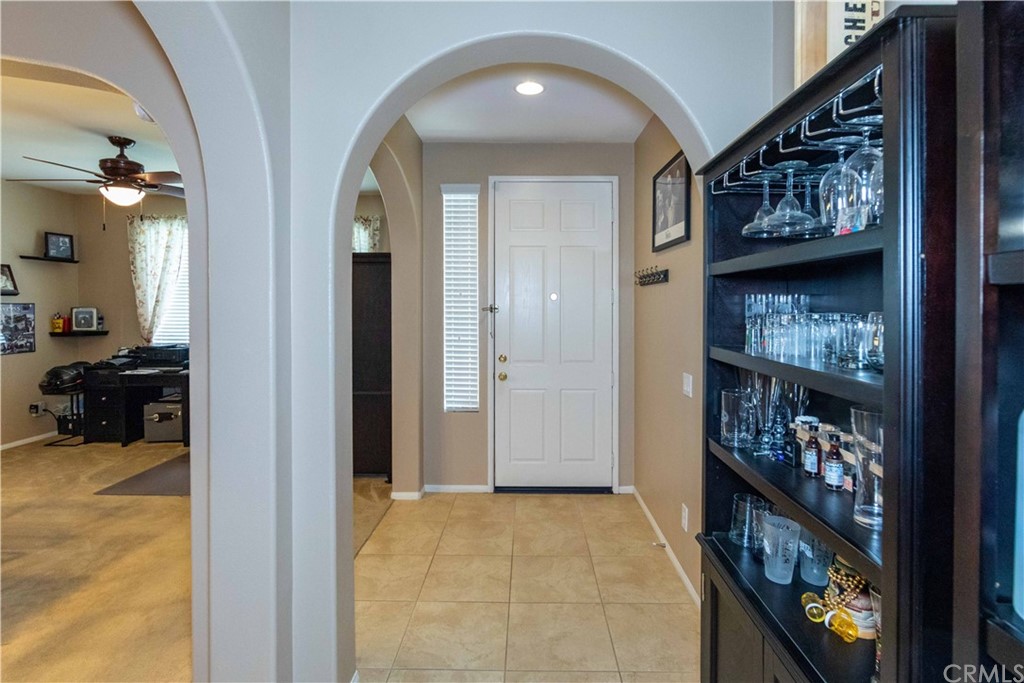 31271 Ensemble Drive Menifee, CA 92584 - Photo 30 of 30 a view of a hallway to a livingroom with furniture and toys