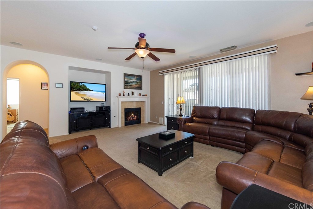 31271 Ensemble Drive Menifee, CA 92584 - Photo 4 of 30 a living room with furniture and a fireplace