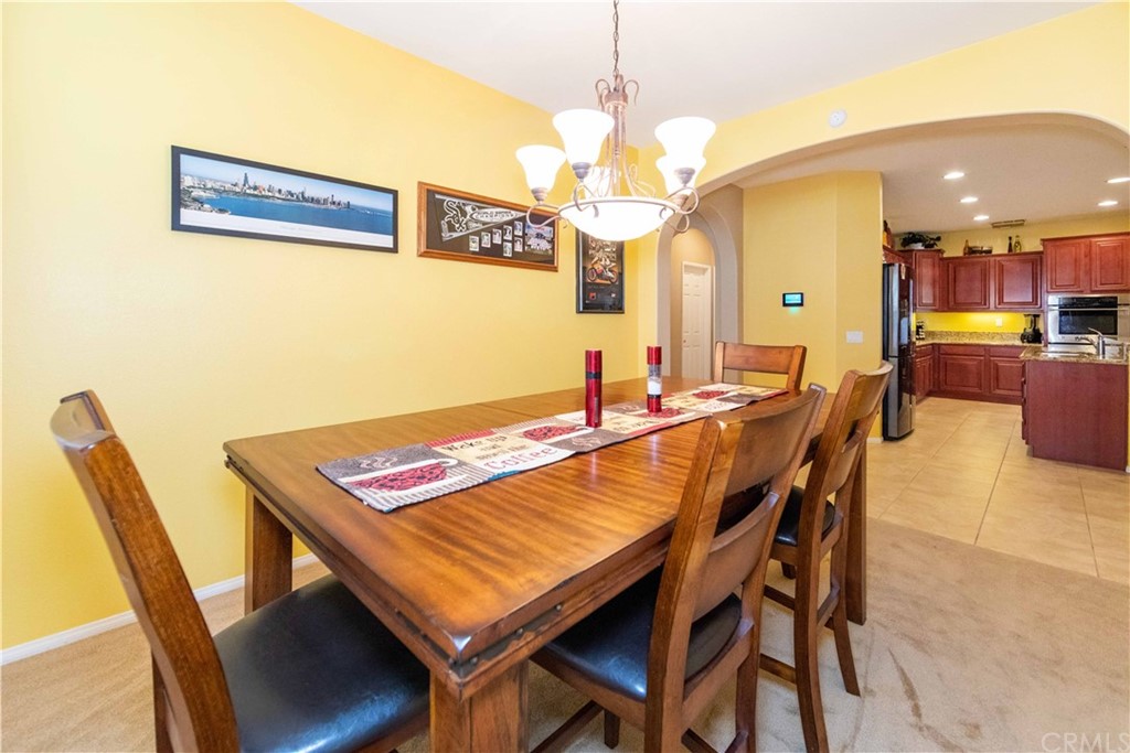 31271 Ensemble Drive Menifee, CA 92584 - Photo 7 of 30 a view of a dining room with furniture and a chandelier