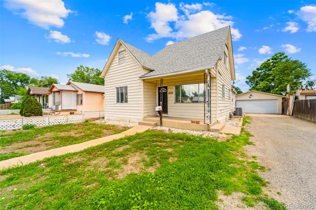 a view of a house with pool and a yard