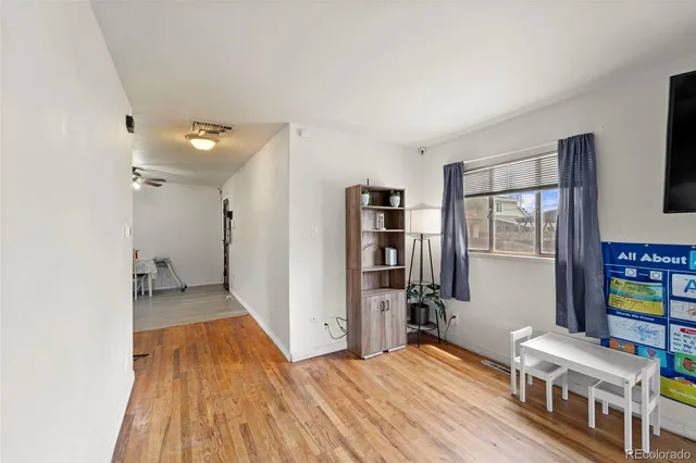 a bedroom with furniture and a book shelf