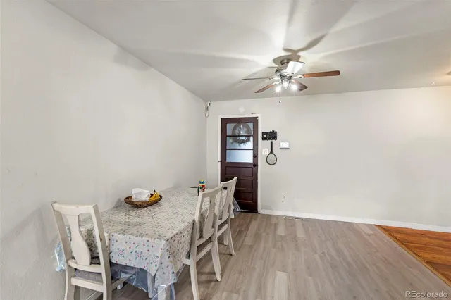 a view of a dining room with furniture and chandelier fan