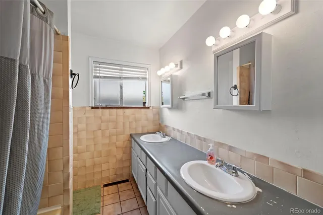 a bathroom with a sink a mirror and a shower