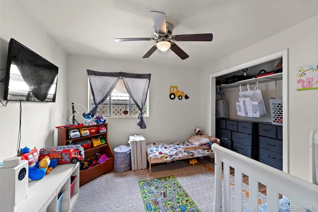 a bedroom with furniture a baby crib and a window