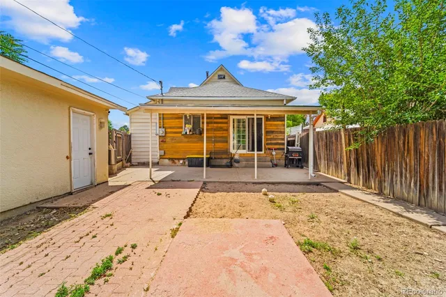 a view of a house with wooden fence