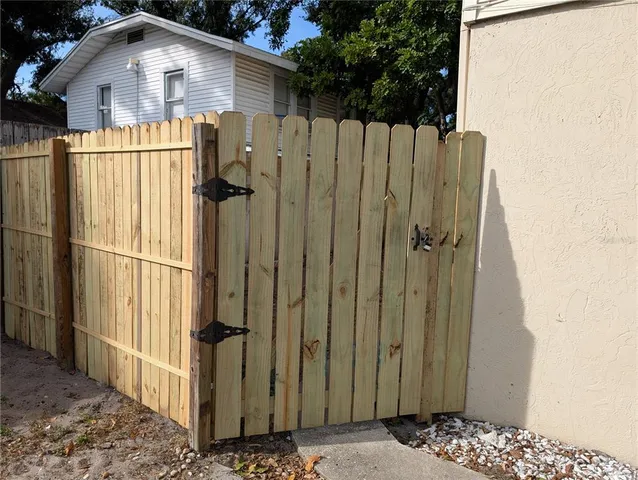 a view of a wooden house with a wooden fence