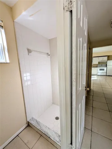a bathroom with a glass door shower and a sink