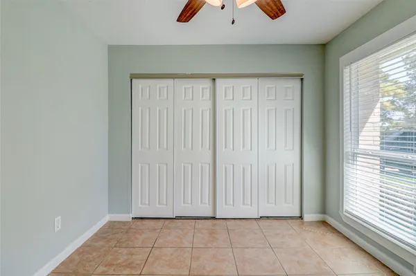 a view of an house with backyard and a tree