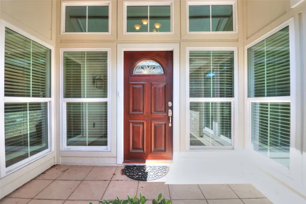 a front view of a brick house with a large window