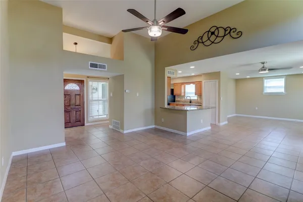 a kitchen with stainless steel appliances granite countertop a refrigerator a stove and a sink