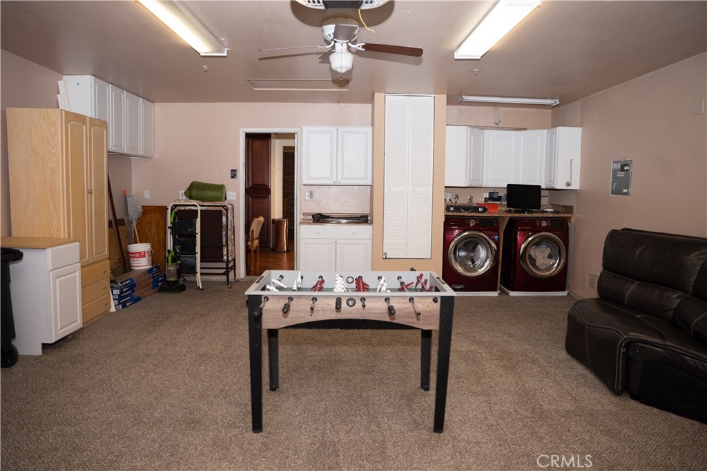 13655 El Rio Lane Desert Hot Springs, CA 92240 - Photo 13 of 27 a living room with furniture a large window and storage