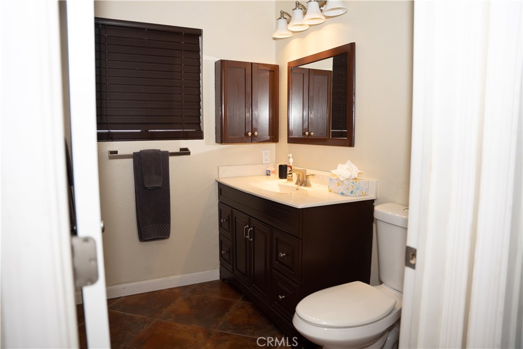 13655 El Rio Lane Desert Hot Springs, CA 92240 - Photo 17 of 27 a bathroom with a sink a toilet and mirror